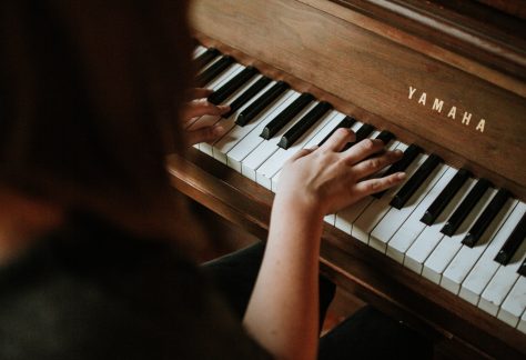 woman playing Yamaha piano